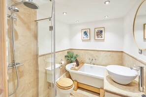 Bathtub, hair dryer, towels, shampoo