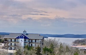 Situated near a body of water, this two-story building offers a balcony with a view of distant hills.