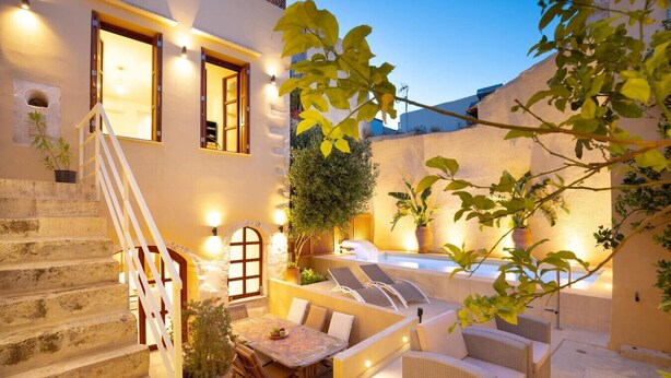 A courtyard with a stone staircase, outdoor seating, and potted plants. - Villa in Rethymno Old Town w/Private Pool & BBQ (Rethymno)