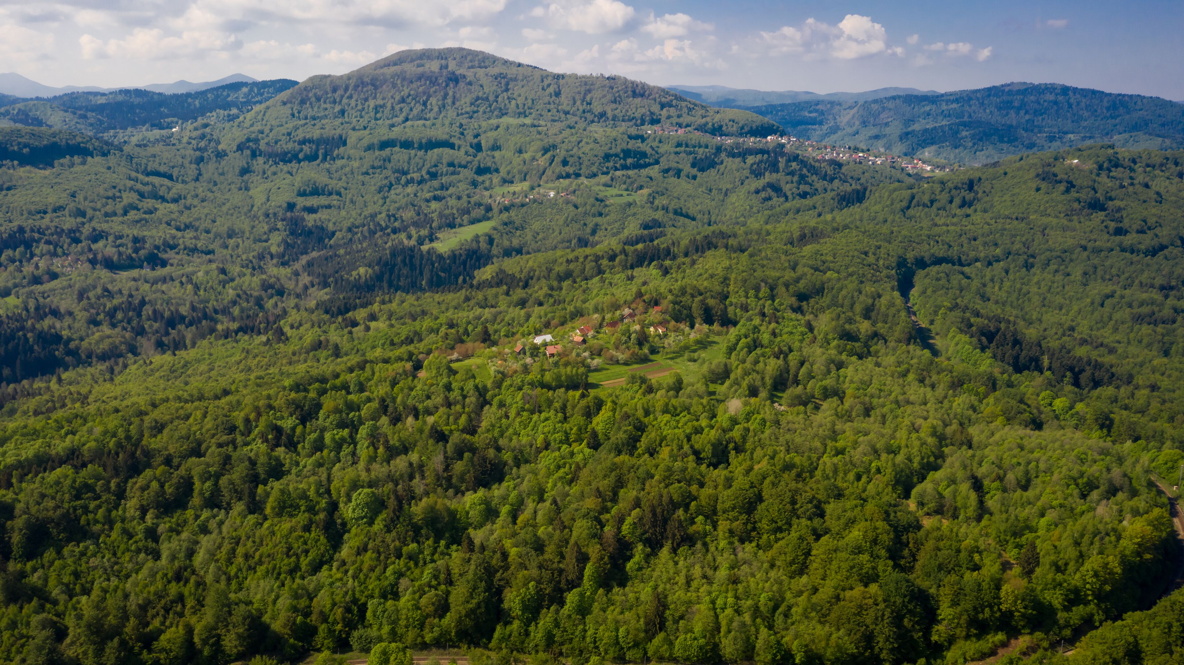 A mountainous landscape with a small village nestled among the hills.
