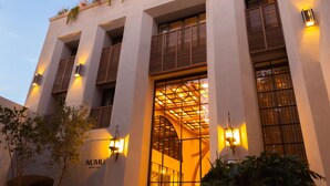 A modern building with a flat facade, large windows, and a sign reading "NUMU". - NUMU Boutique Hotel, The Unbound Collection by Hyatt (San Miguel de Allende)
