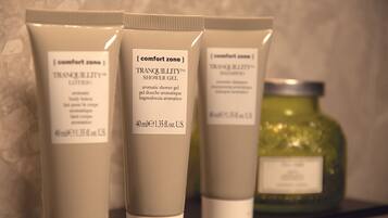 Three toiletry items on a shelf.
