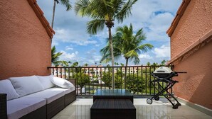 A balcony with a wicker sofa, a small table, and a grill. - Beach Villages,  3 Bedrooms, Just Renovated (Humacao)