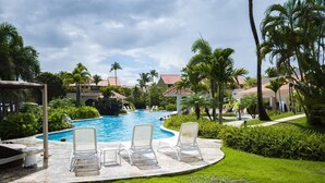 A pool area with lounge chairs and a gazebo. - Beach Villages,  3 Bedrooms, Just Renovated (Humacao)