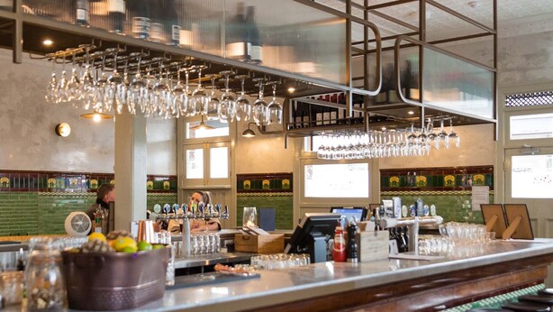 A bar area with a counter, stools, and a variety of glassware. - Terminus Pyrmont (Pyrmont)