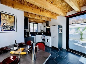 A modern kitchen with a wooden ceiling, a washing machine, and a refrigerator. - ⭐ Le Grand Sabouillon ⭐ Loft-style villa ⭐ private pool ⭐ Mont Ventoux view ⭐ (Buis-les-Baronnies)