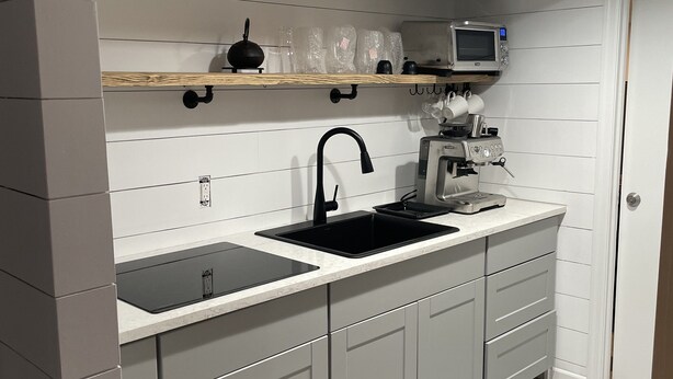 A modern kitchen with a double sink, a microwave, and a coffee machine. - Hamptons Apartment in Lower Part of a House (Hampton Bays)