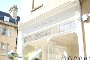 A building facade with the text "EIGHT HOLLAND STREET" and a window with a grid pattern.