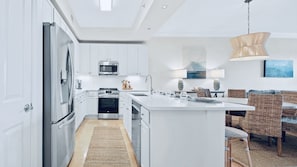 Enjoy cooking in this well-equipped kitchen with a gas range, microwave, and ample counter space.