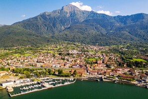 A coastal town with a marina, surrounded by mountains.