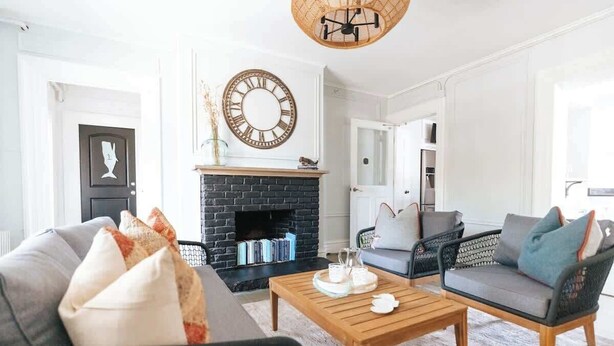 A living room with a fireplace, a sofa, a chair, and a coffee table.