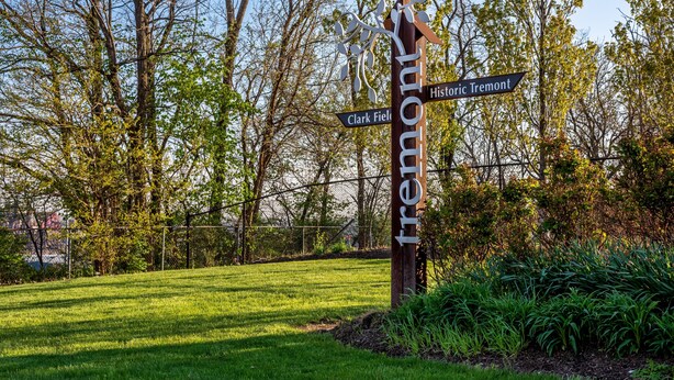 A wooden signpost with directions to Historic Tremont and Clark Field. - Tremont  1BR  Pet Friendly, Private w/dedicated workspace and soaking tub! (Cleveland)
