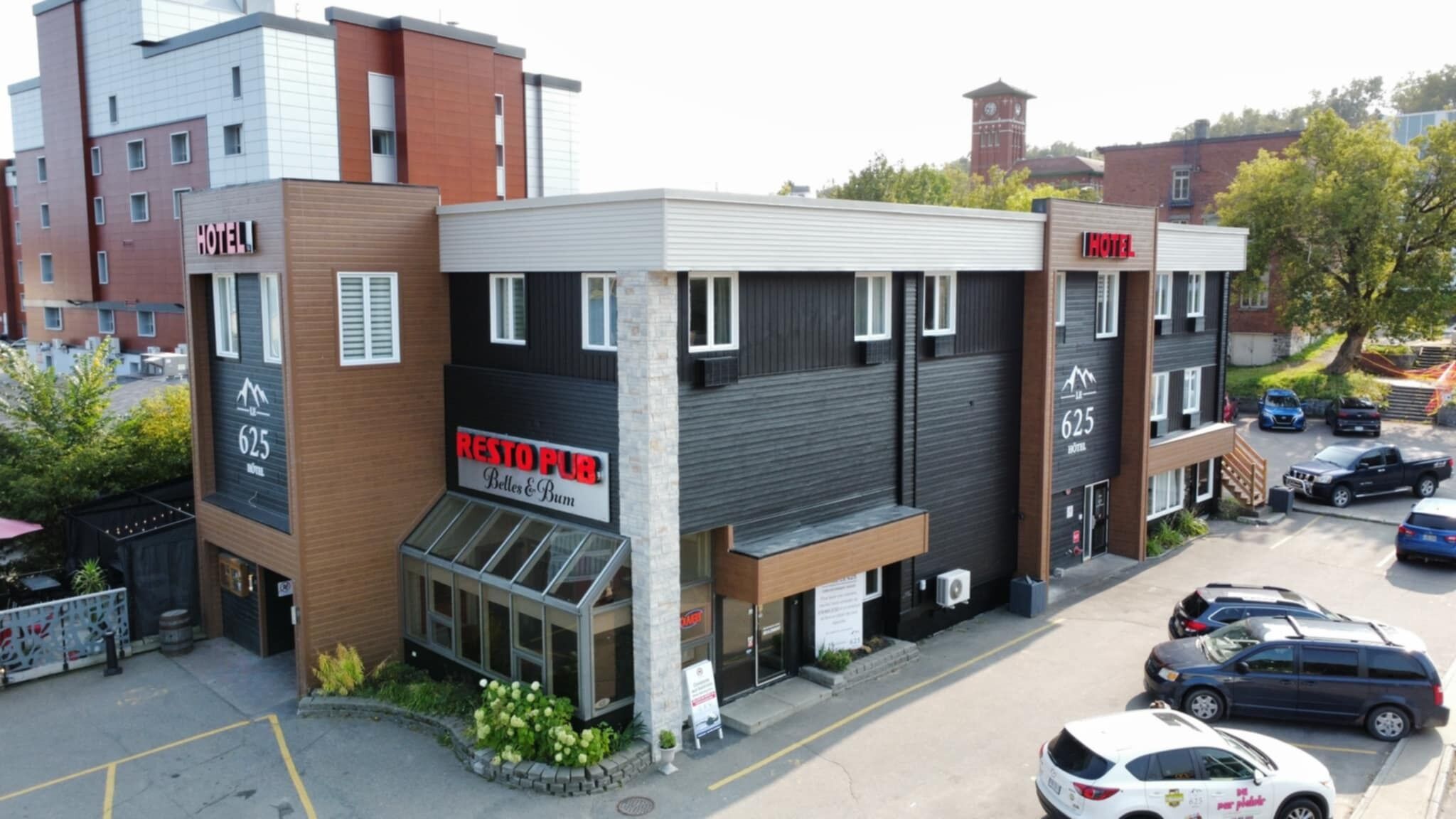 A hotel with a modern design, featuring a restaurant named 'Resto Pub' on the ground floor.