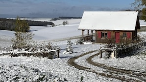 A wooden cabin with a snow-covered roof, surrounded by a snowy landscape and a clear sky. - Le Chevrais - PAISY COSDON (PAISY COSDON)