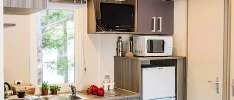 Fridge, microwave, coffee/tea maker, cookware/dishes/utensils