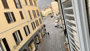 A street view with buildings, a white van, and a few pedestrians.