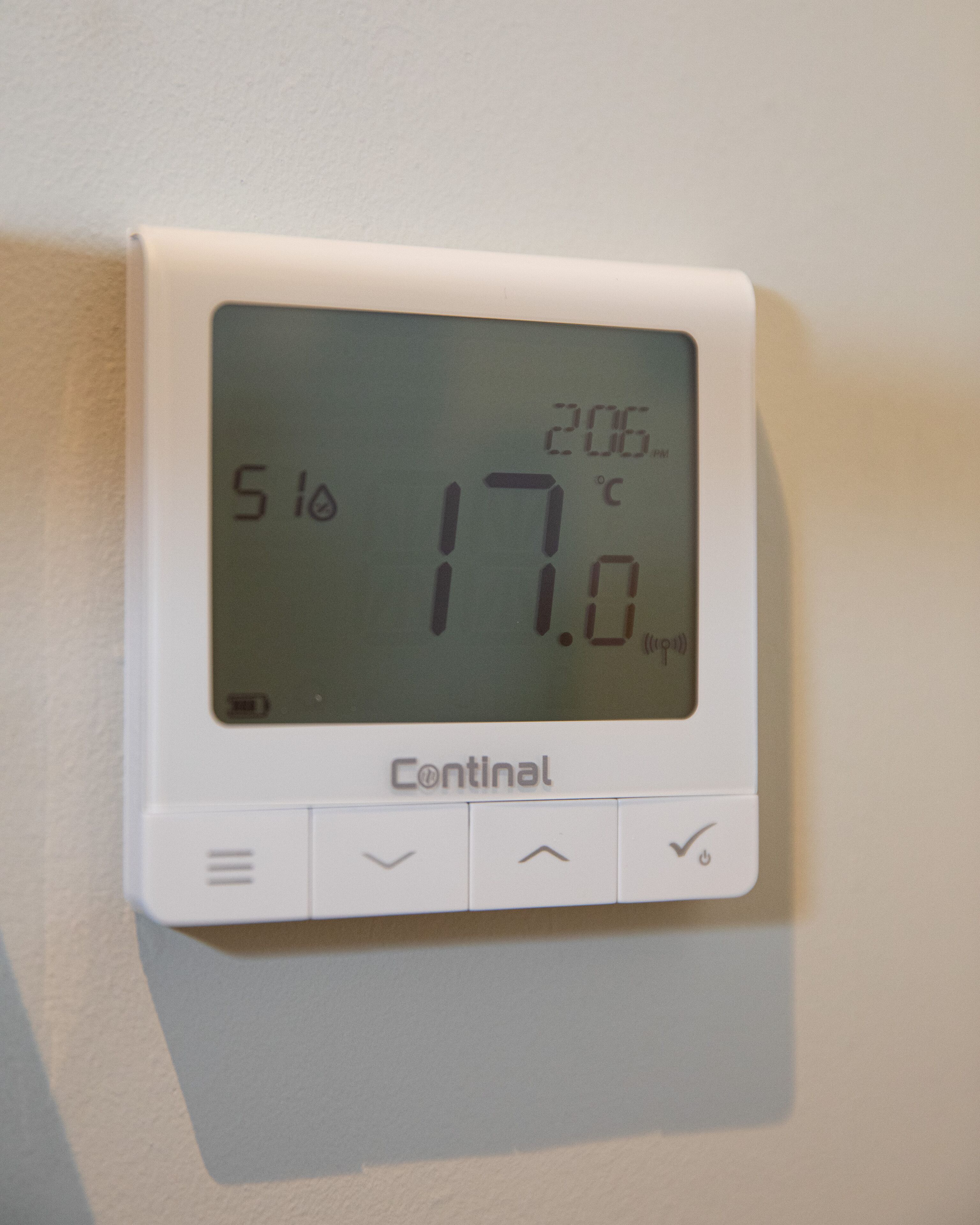 A thermostat displaying a temperature of 17.0°C.