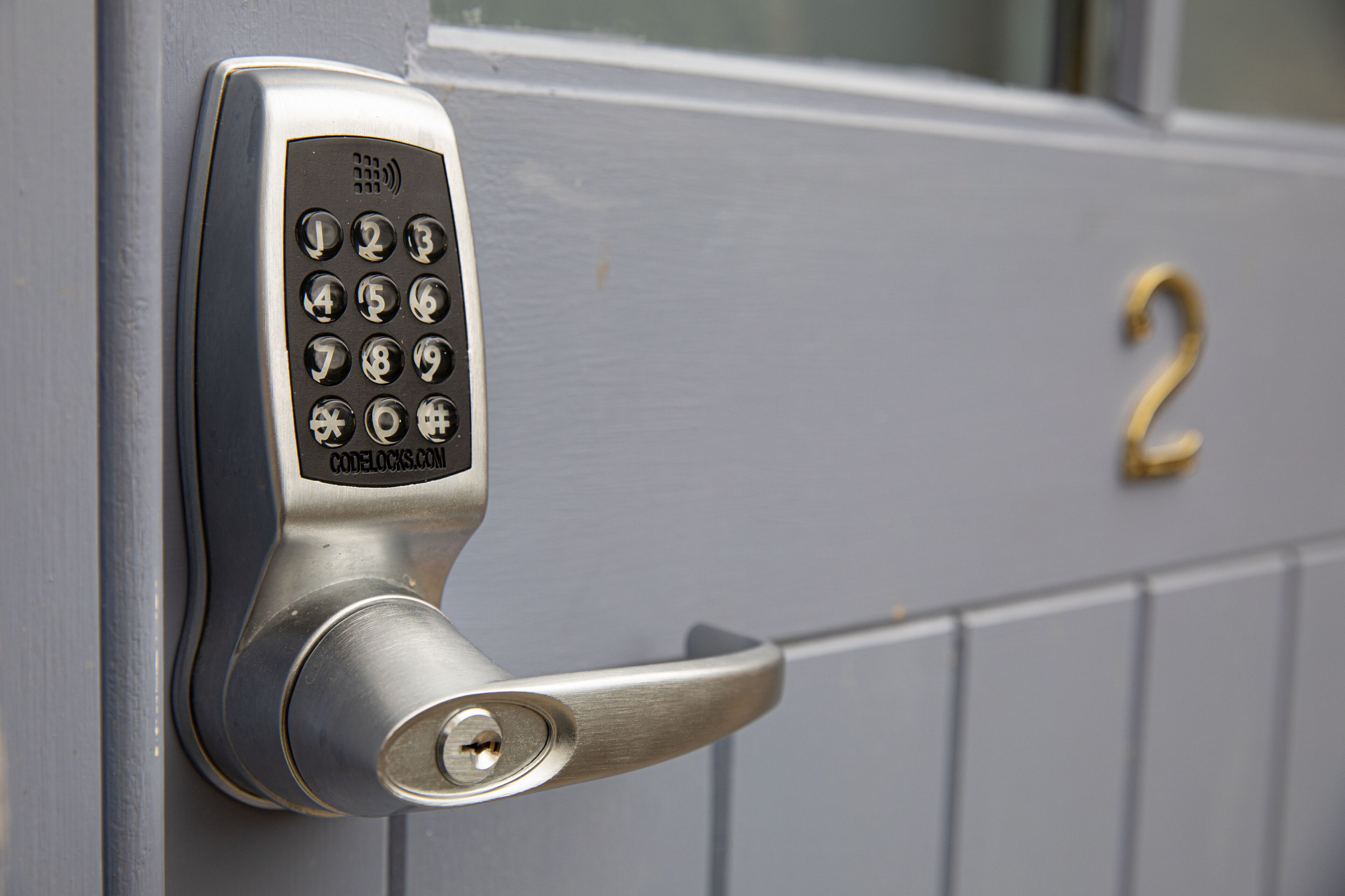 A door with a numeric keypad lock and a keyhole.