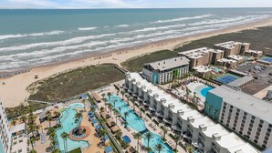 A resort with multiple swimming pools, beachfront views, and a beach area with umbrellas. - 3/3 Sapphire Condo 23rd Floor, Ocean & Bay View Balconies, Corner Unit, NO FEES! (South Padre Island)