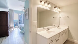 A bathroom with a large mirror, two sinks, and a vanity with drawers. - Walking distance to the beautiful Gulf of Mexico beaches (Miramar Beach)