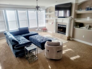 Smart TV, fireplace, books, computer monitors