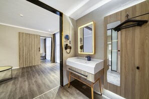 A modern bathroom with a white sink, wooden vanity, and a large mirror. - Hanting Hotel (china Home Textile City Store in Xu (Jiaxing)