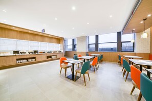 A modern dining area with wooden paneling, tiled flooring, and colorful chairs. - Hanting Hotel (china Home Textile City Store in Xu (Jiaxing)