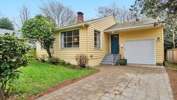 Stroll up to the front door, flanked by two windows, and enter this charming home.