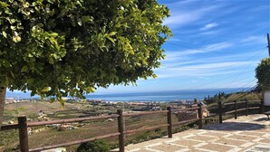 A paved terrace with a wooden railing overlooking a coastal landscape. - Manilva Coastal Retreat for over 50 's (Manilva)