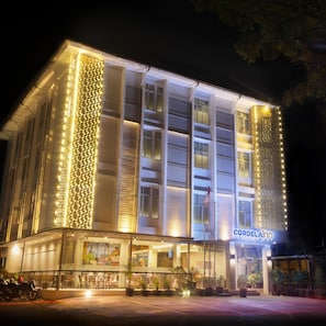 A hotel with a modern facade, illuminated vertical light patterns, and a visible sign reading 'CORDELAIR'. - Cordela Inn Bengkulu (Bengkulu)