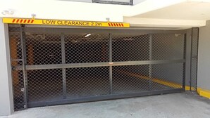 A gated parking area with a low clearance sign indicating 2.2 meters. - KULA - Apartment Parramatta (Mays Hill)