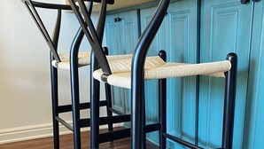 Two black metal chairs with woven seats against a teal wall. - Labor Day Sale - Limited Time Offer, Save up to 30% (Park City)