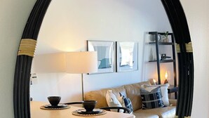 A cozy living area with a sofa, a table with two bowls, a lamp, and framed pictures on the wall. - Labor Day Sale - Limited Time Offer, Save up to 30% (Park City)