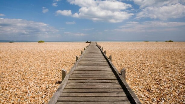 A wooden pier extending into a pebble beach under a partly cloudy sky. - West Cottage -  charming seaside cottage by Bloom Stays - 4 guests  in 2 bedrooms (Dungeness)