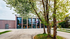 A Premier Inn hotel with a modern facade, large windows, and a well-maintained outdoor area with trees.
