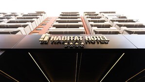 The exterior of a modern hotel with a prominent sign reading "HABITAT HOTEL" and five stars. - Habitat Hotel Tirana (Tirana)