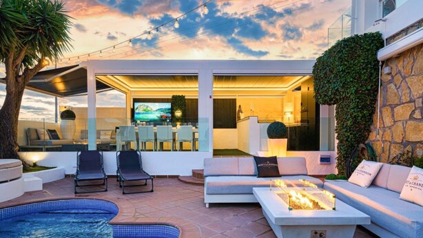 A modern outdoor living area with a pool, seating, and a view of the sky. - Villa Vega with Pool, Garden & Wi-Fi (Alfaz del Pi)