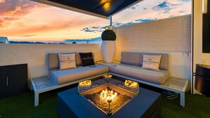 A modern outdoor seating area with a fire feature, a sofa set, and a decorative plant. - Villa Vega with Pool, Garden & Wi-Fi (Alfaz del Pi)