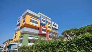 Un edificio de varios pisos con un diseño arquitectónico único, caracterizado por una serie de secciones rectangulares apiladas en distintos colores.