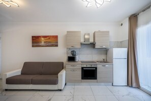 A modern kitchen with a built-in oven, microwave, and a stainless steel range hood.