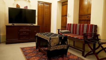 Standard Room | Living area | 65-inch LED TV with digital channels, TV