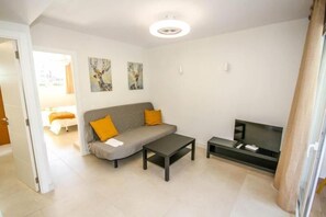 Superior Apartment | Living area | 27-inch flat-screen TV with satellite channels, TV