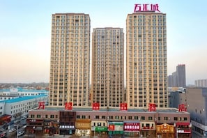 A high-rise building with multiple floors, likely a hotel or residential complex, with a clear view of the surrounding area. - Wanxi Tiantian Hotel (Shenyang)