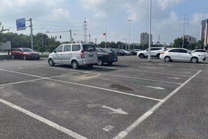 A parking lot with multiple cars and a clear sky.