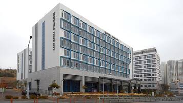 A modern hotel building with a grid of windows and a flat facade.