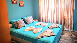 A room with a bed, a wall-mounted air conditioner, and two paintings. - All Inclusive Luxury Villa With sea View (Sozopol)