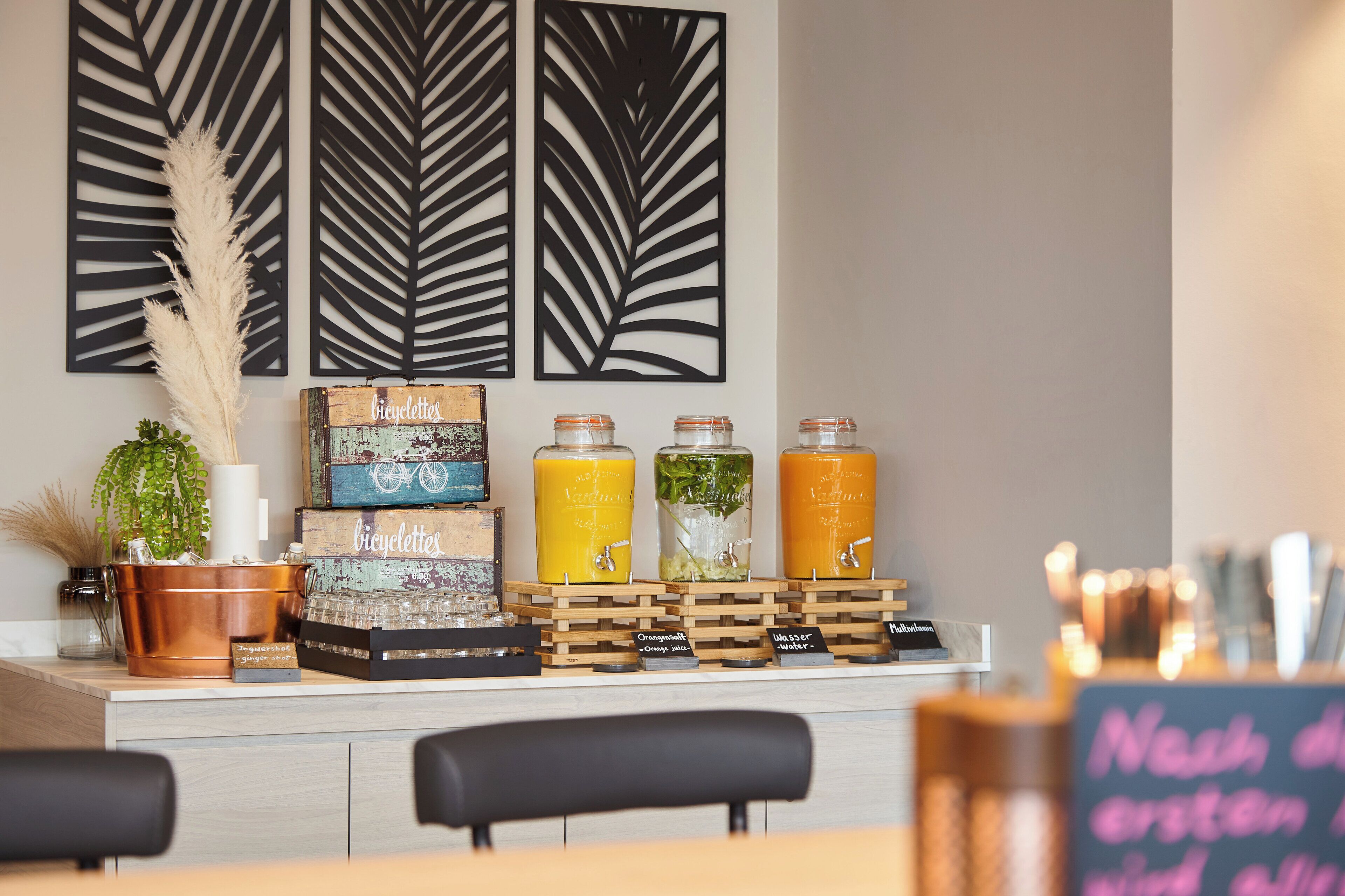 A bar area with a selection of beverages, a rustic sign, and decorative wall panels.