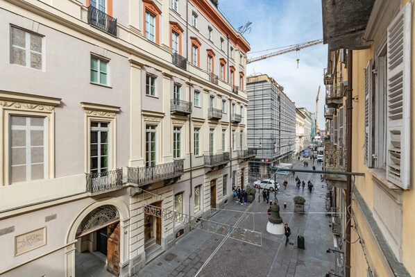 A historic building with multiple floors, ornate balconies, and a central courtyard.