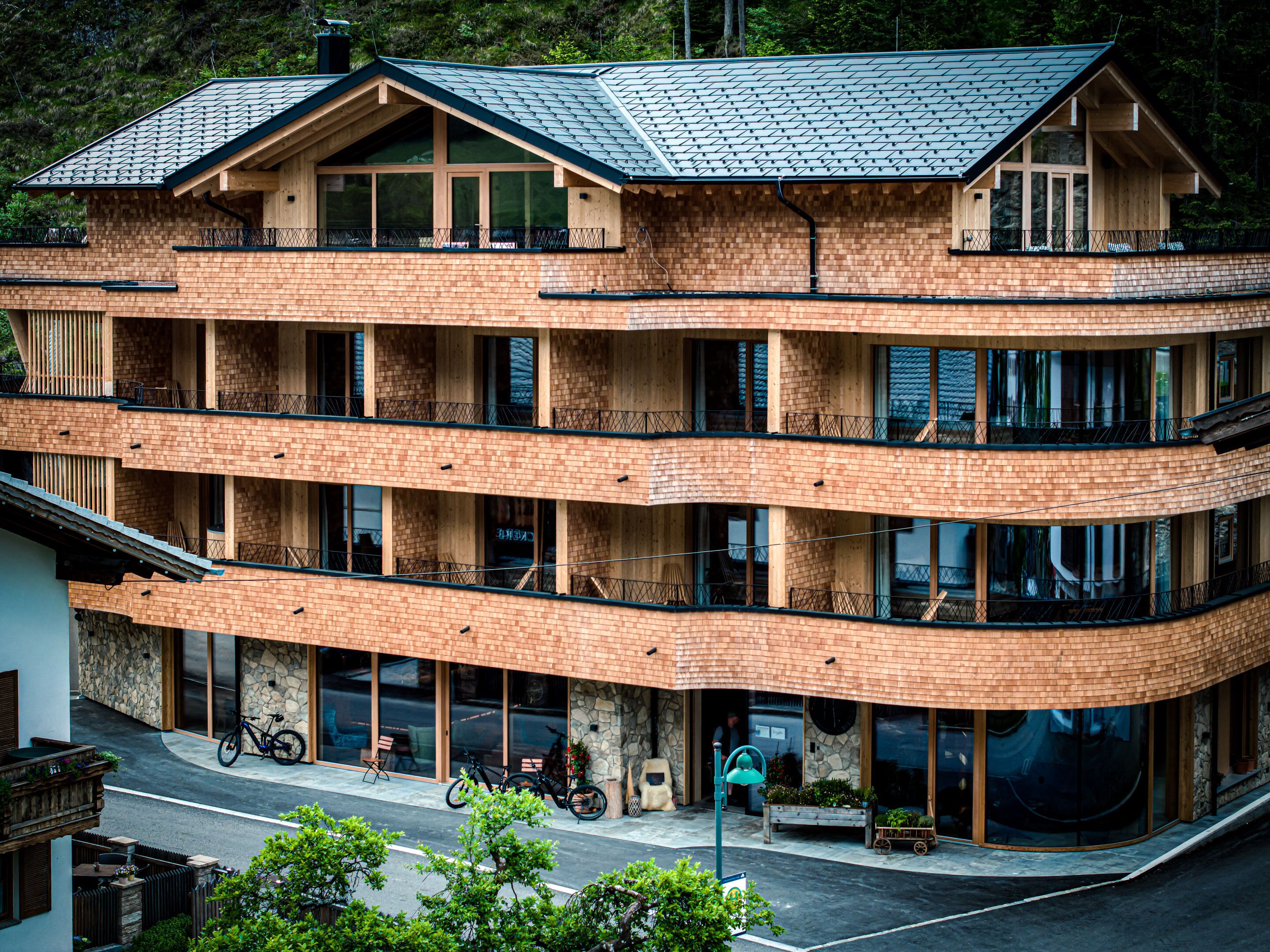 A multi-story building with a brick facade, large windows, and balconies.
