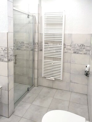 Bathtub, hair dryer, soap, toilet paper
